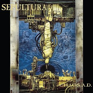 Chaos A.D. album cover: a bound, hooded figure hanging upside down from a towering yellow machine above a crowd of raised hands, with the Sepultura logo at top