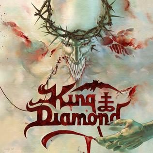 Album cover in pale washed reds and creams: a horned, grinning demonic face crowned with thorns, above the red King Diamond logo and a reaching hand