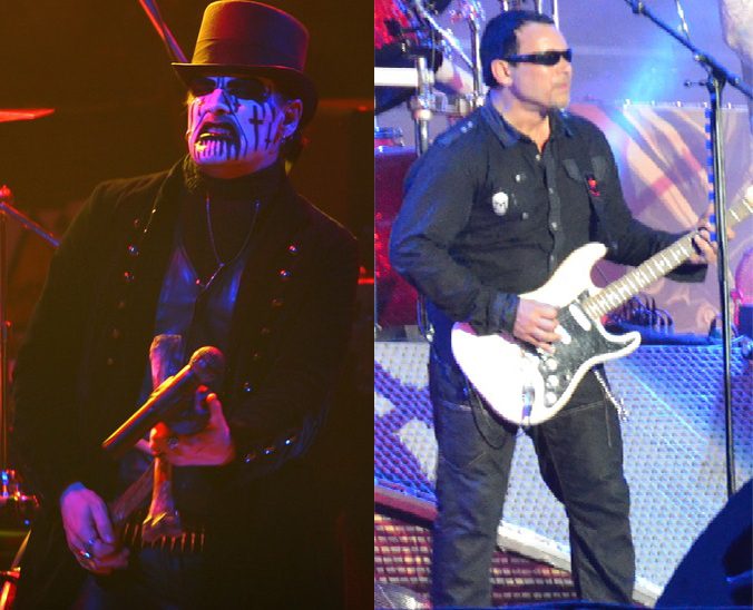 Two side-by-side live photos: on the left King Diamond in black-and-white face paint and a top hat, gripping a microphone mounted on a bone-shaped stand; on the right Hank Shermann in sunglasses and a black shirt, playing a white guitar with a black pickguard