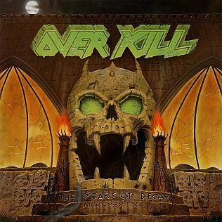Cover of Overkill's The Years of Decay: a green-eyed stone skull gateway flanked by burning torches under a full moon
