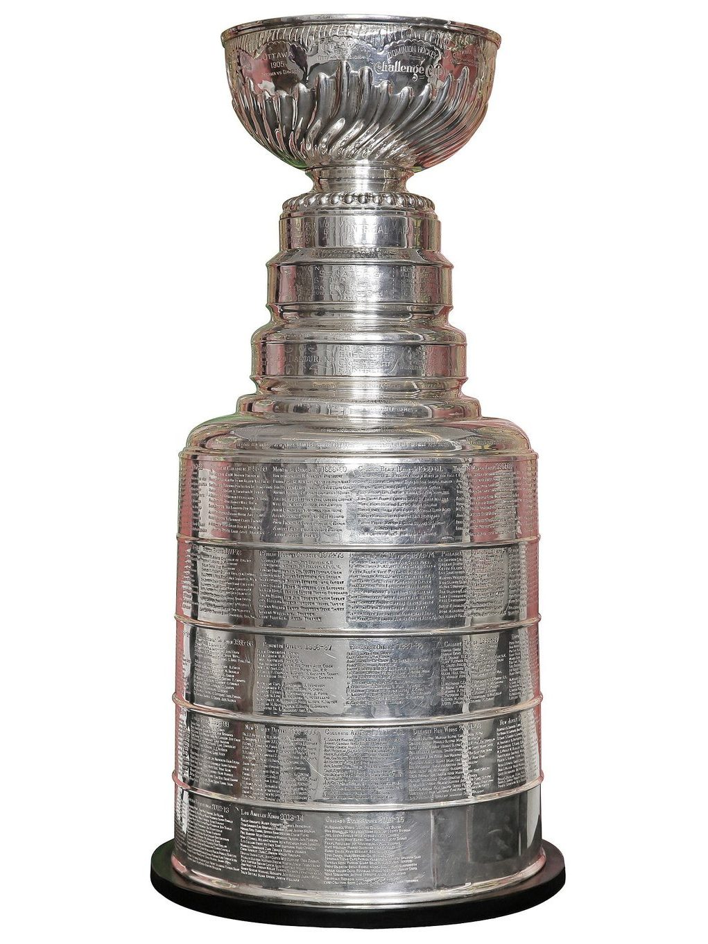 The Stanley Cup on display, a tall silver trophy with a bowl on top and engraved bands of names below