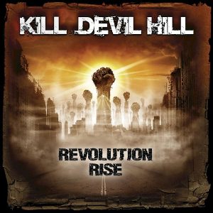 Revolution Rise album cover: a raised fist above a crowd of upraised arms on a long road through a smoky, ruined city, under the Kill Devil Hill logo
