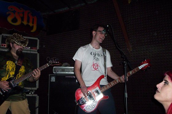 Bass and guitar, shoulder to shoulder.